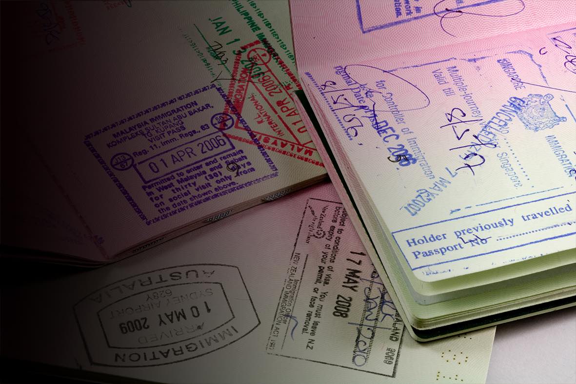 Passport pages with various international stamps.