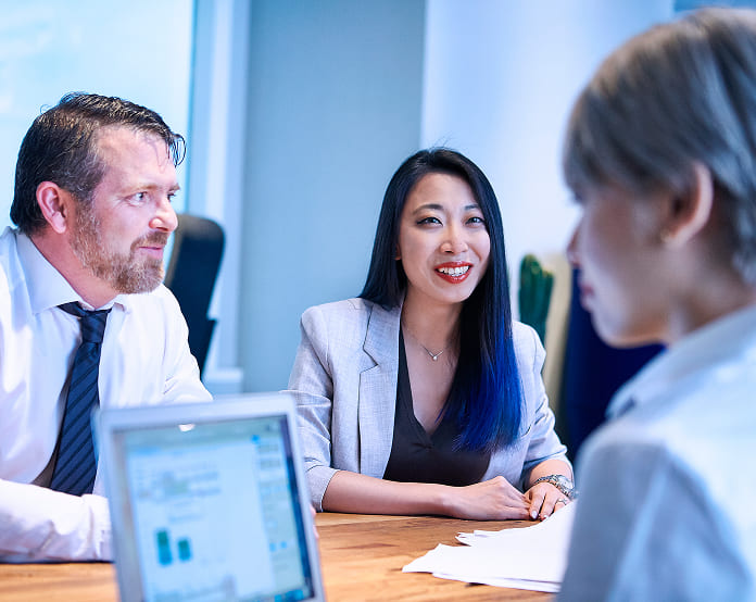 Business meeting with diverse professionals discussing strategy.